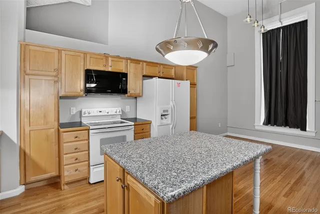 a kitchen with stainless steel appliances granite countertop a sink refrigerator stove and microwave