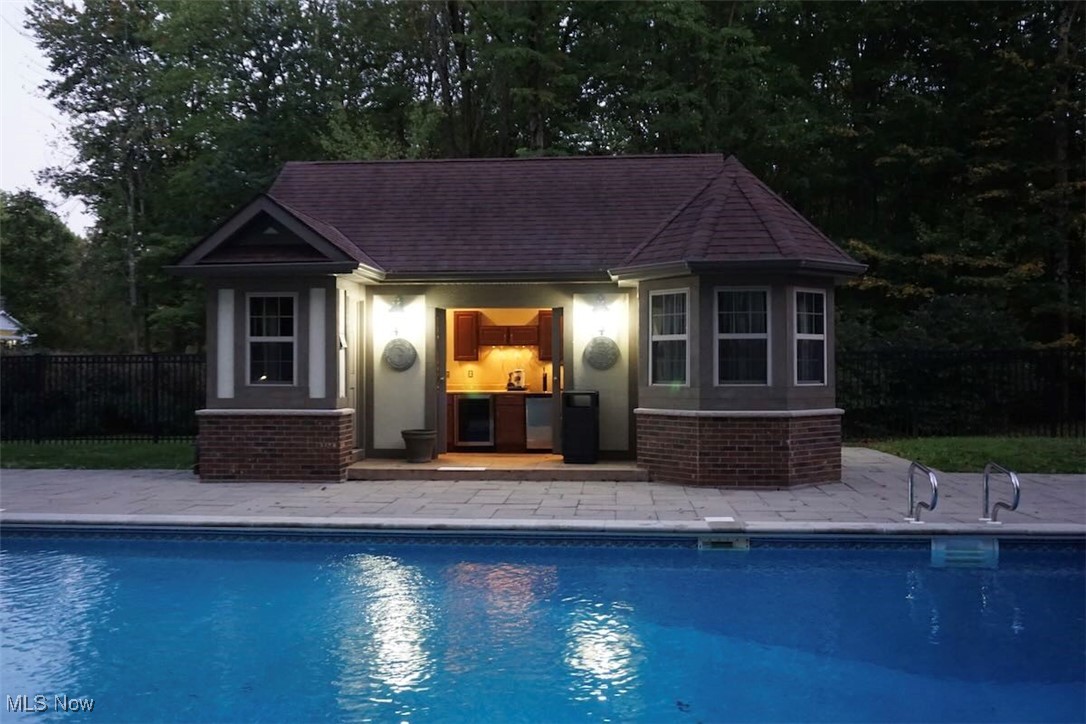 1760 Chartley Road Gates Mills, OH 44040 - Photo 35 of 49 View of swimming pool featuring a cabana with wine refrigerator, keg cooler, refrigerator. Full bathroom and changing area.