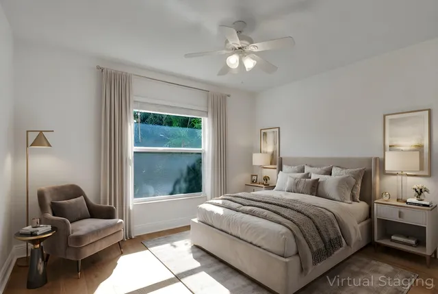 a bedroom with a bed and a large window