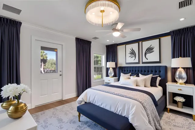 a bedroom with bed and a chandelier