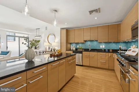 a kitchen with sink stove and cabinets