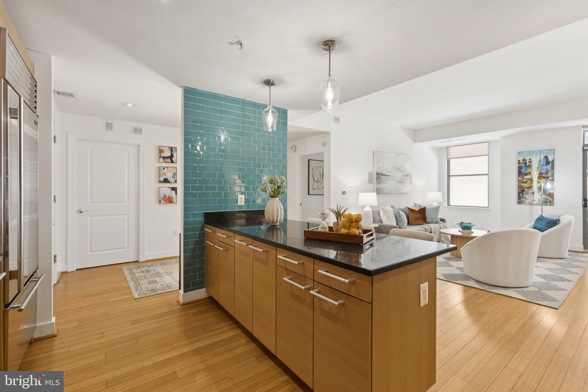 2425 L Street Northwest, Unit 210 Washington, DC 20037 - Photo 13 of 39 a kitchen with stainless steel appliances granite countertop a sink stove and wooden floor