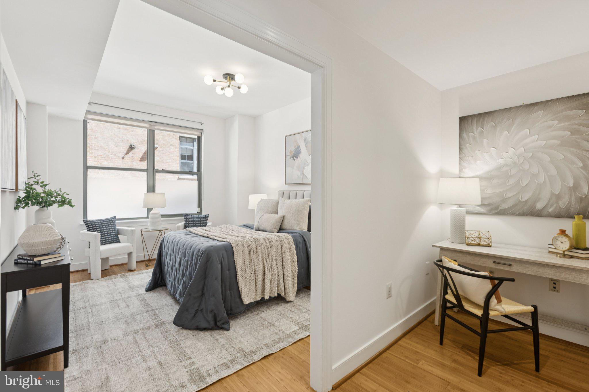 2425 L Street Northwest, Unit 210 Washington, DC 20037 - Photo 15 of 39 a bed room with a bed and a chair