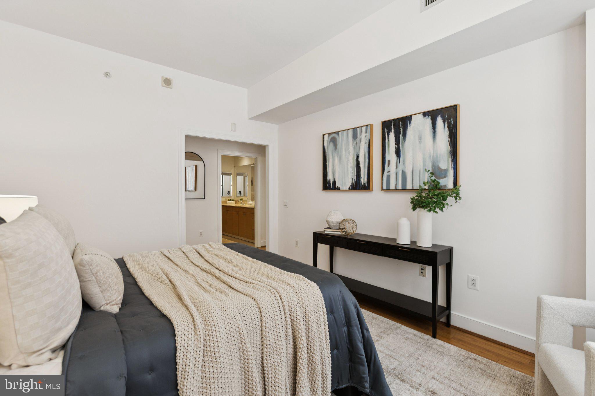 2425 L Street Northwest, Unit 210 Washington, DC 20037 - Photo 17 of 39 a bedroom with a bed and wooden floor