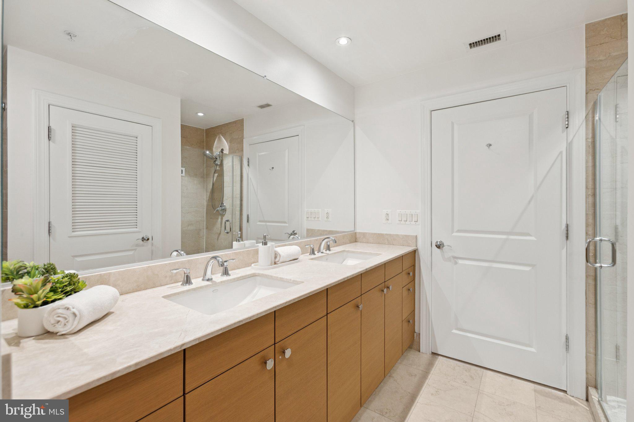 2425 L Street Northwest, Unit 210 Washington, DC 20037 - Photo 21 of 39 a bathroom with a granite countertop sink and a mirror