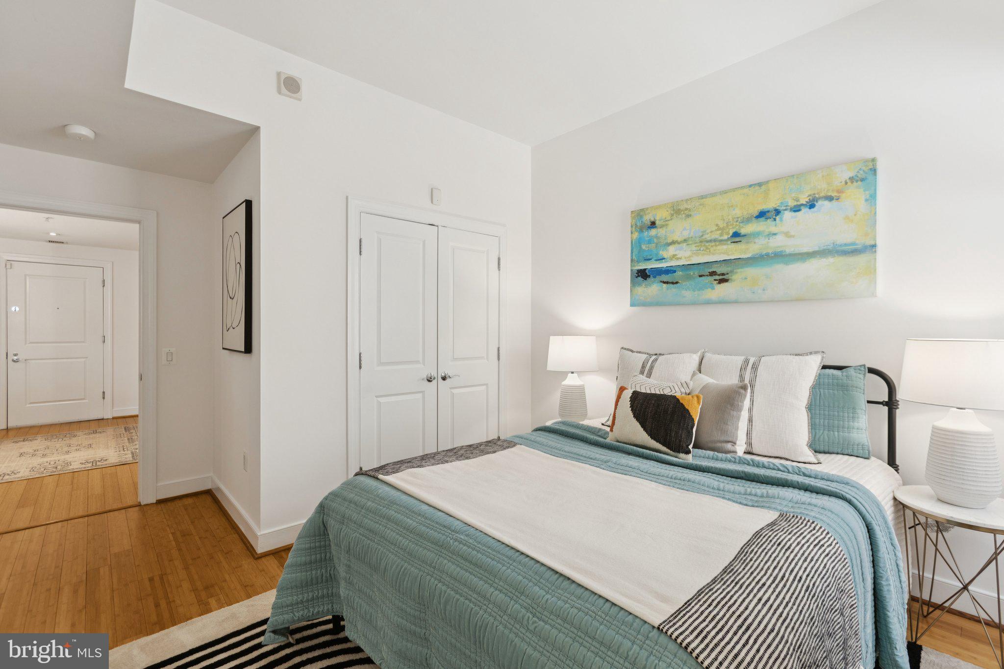 2425 L Street Northwest, Unit 210 Washington, DC 20037 - Photo 25 of 39 a bedroom with a bed and wooden floor