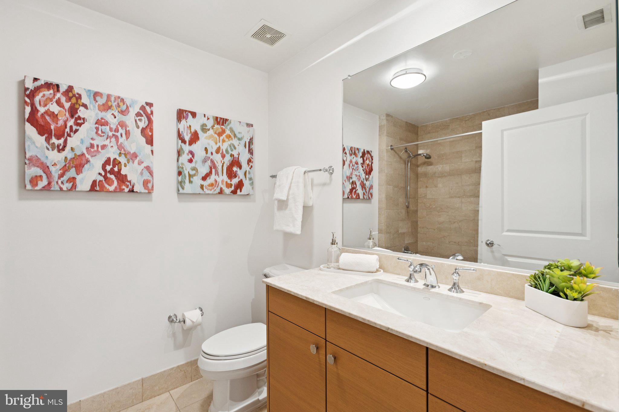 2425 L Street Northwest, Unit 210 Washington, DC 20037 - Photo 27 of 39 a bathroom with a sink toilet and a mirror