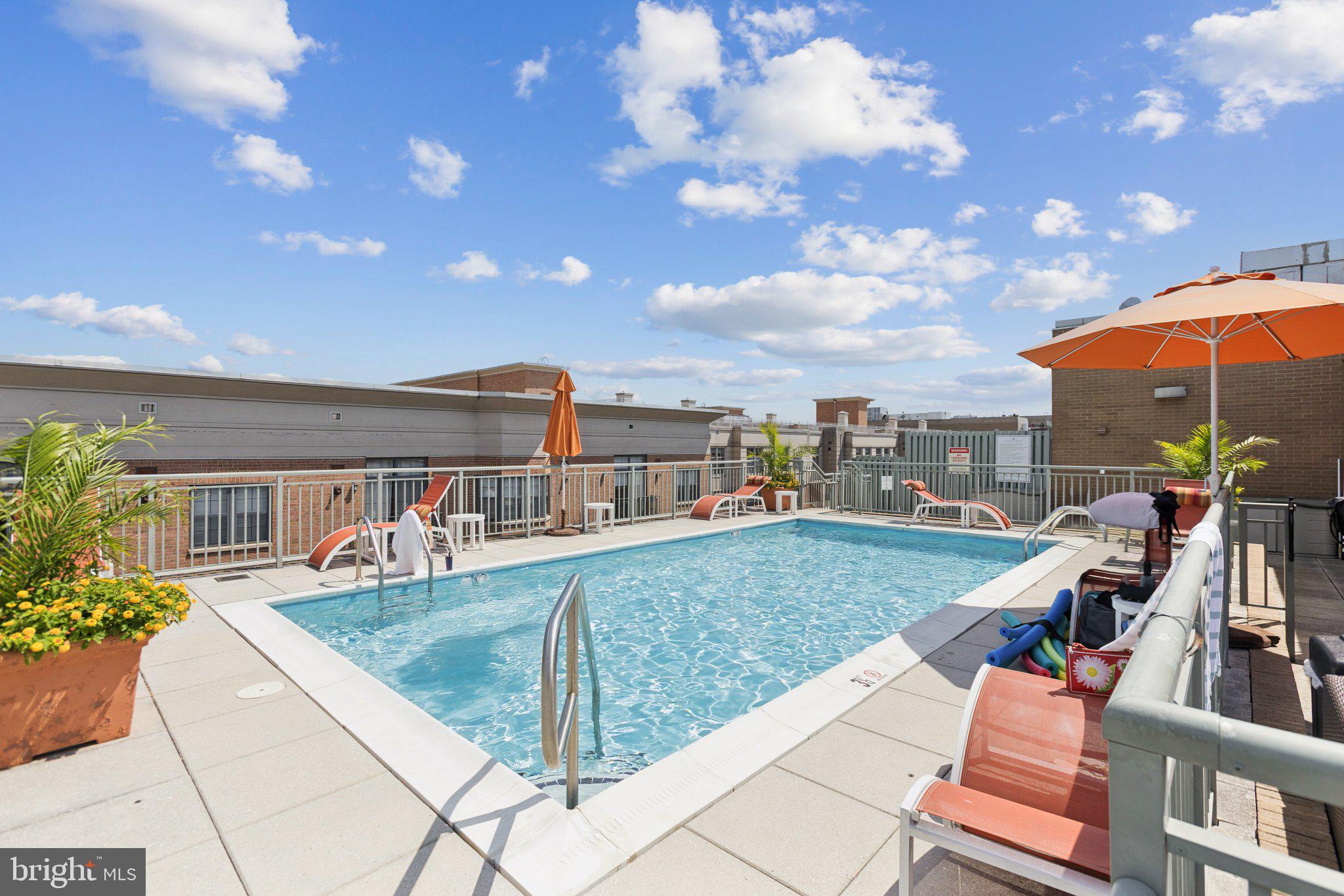 2425 L Street Northwest, Unit 210 Washington, DC 20037 - Photo 33 of 39 a view of a swimming pool with a patio and a yard
