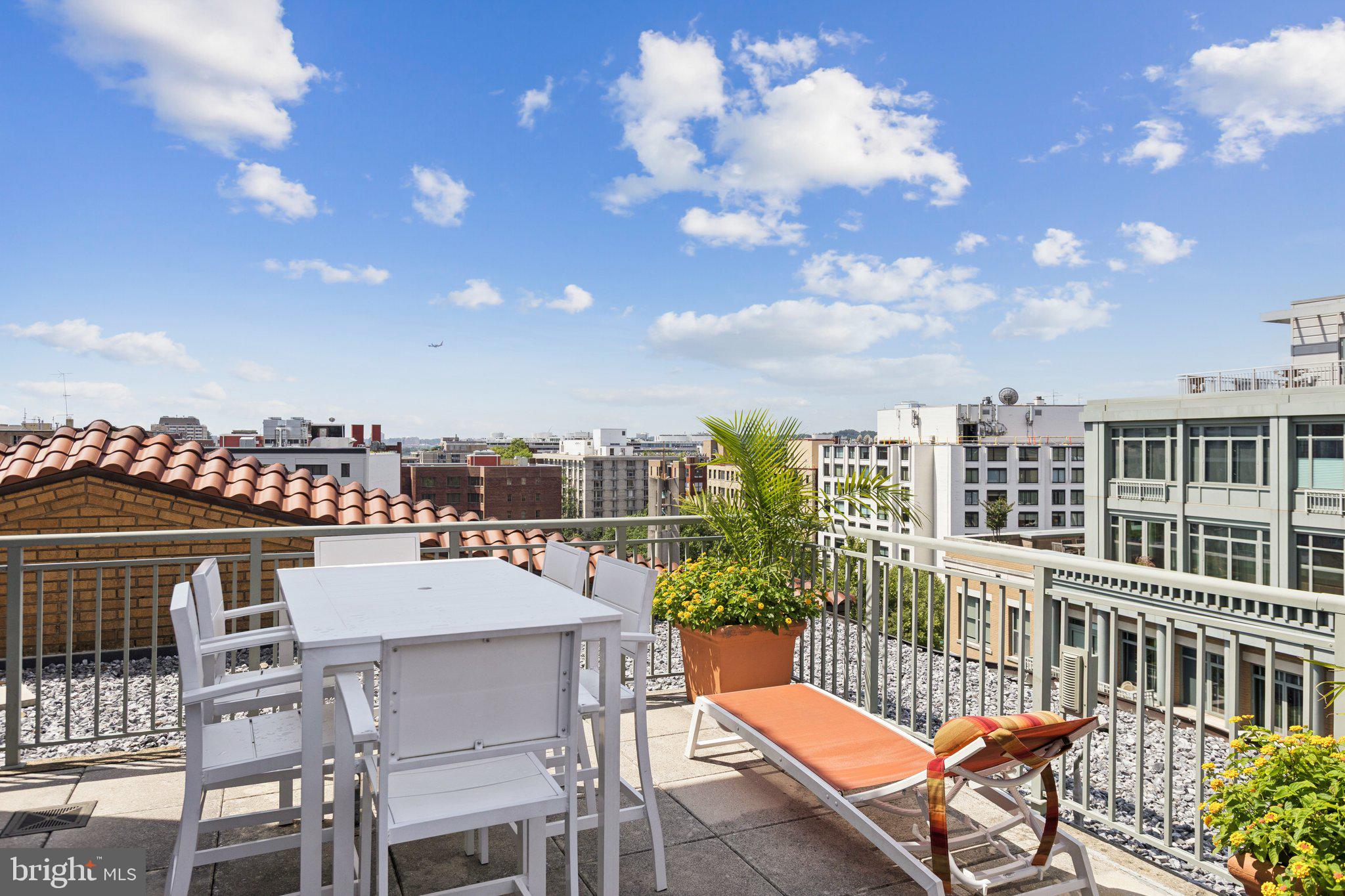 2425 L Street Northwest, Unit 210 Washington, DC 20037 - Photo 35 of 39 a view of a balcony with a dinning table and chairs