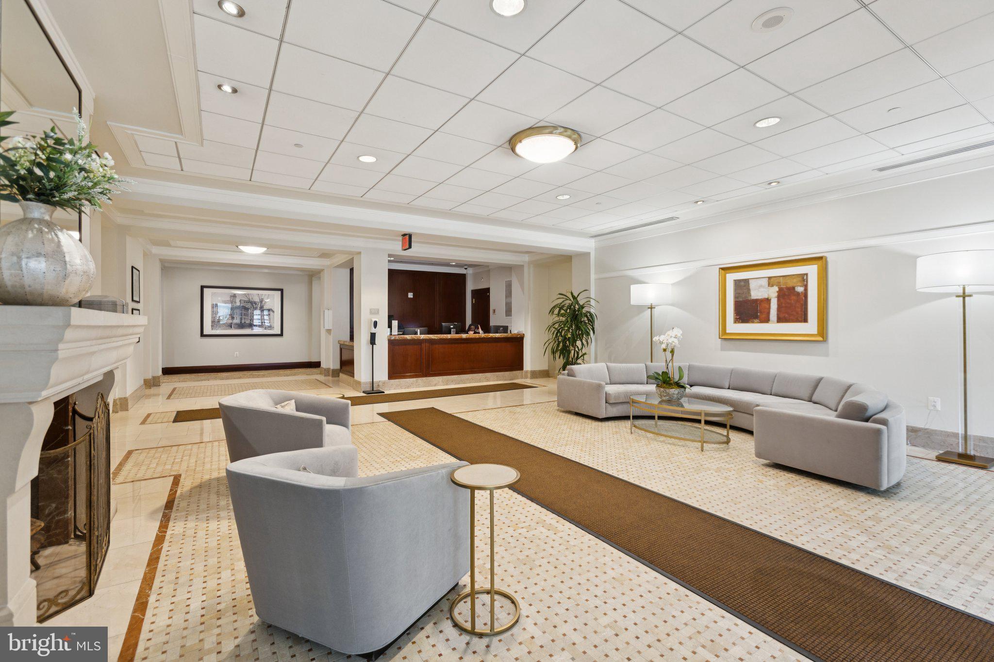 2425 L Street Northwest, Unit 210 Washington, DC 20037 - Photo 38 of 39 a living room with fireplace furniture and a flat screen tv