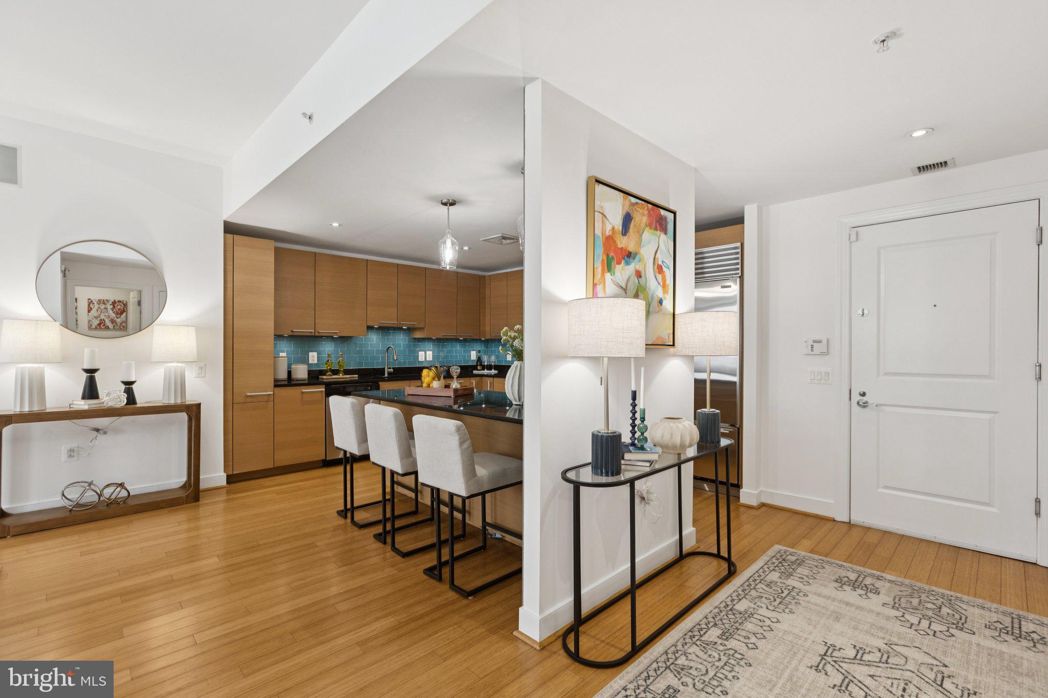 2425 L Street Northwest, Unit 210 Washington, DC 20037 - Photo 4 of 39 a kitchen with a sink cabinets and wooden floor