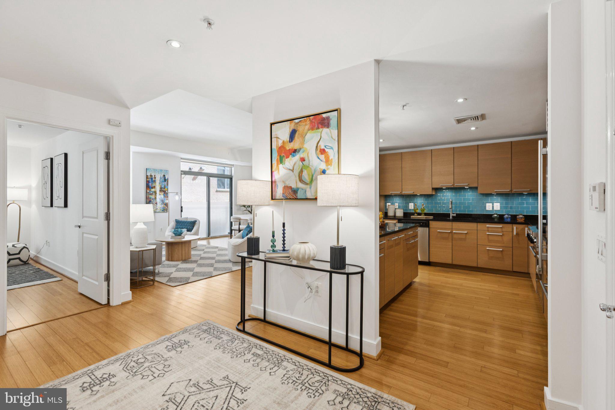 2425 L Street Northwest, Unit 210 Washington, DC 20037 - Photo 5 of 39 a kitchen with stainless steel appliances granite countertop a refrigerator and a stove top oven