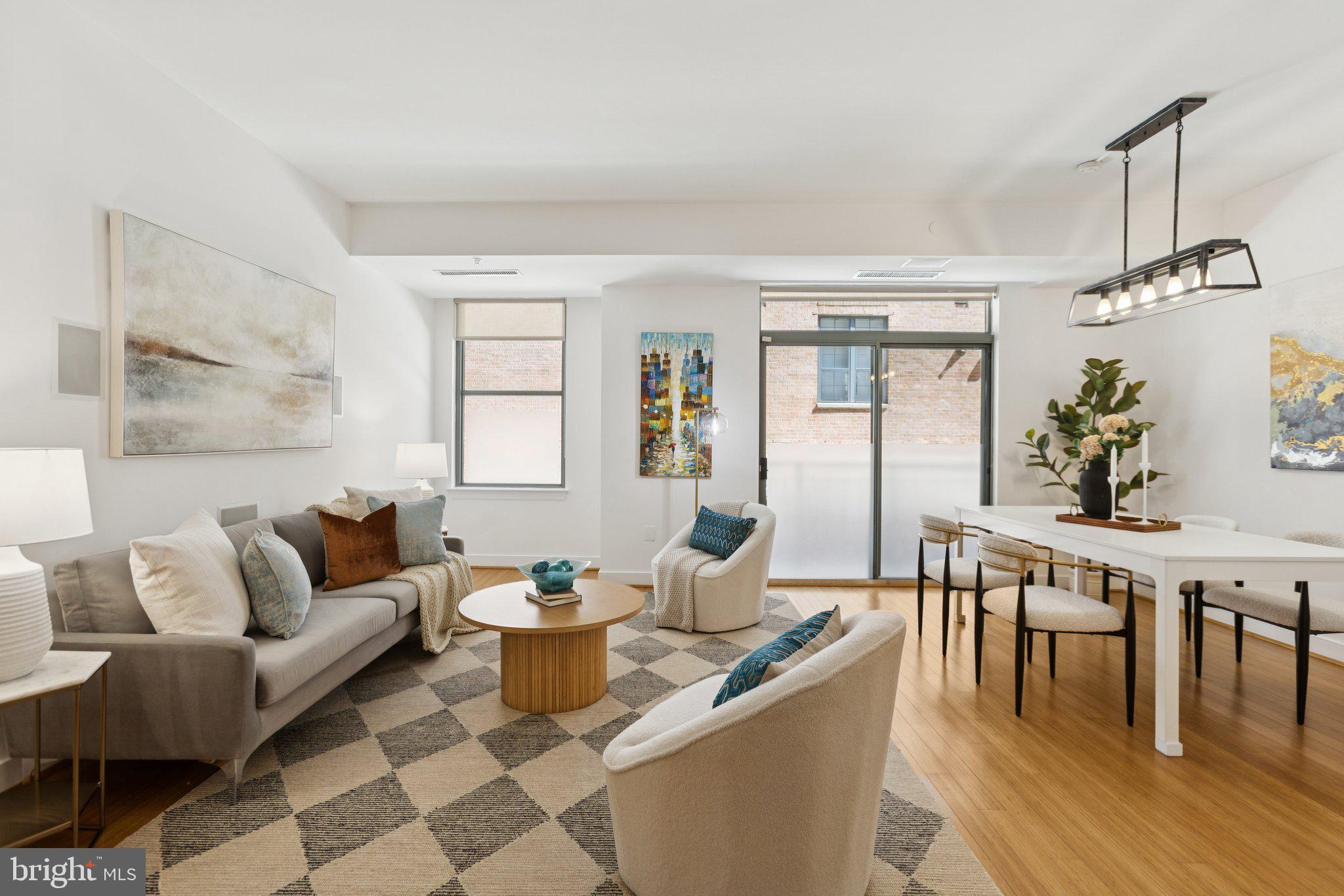 2425 L Street Northwest, Unit 210 Washington, DC 20037 - Photo 7 of 39 a living room with furniture and wooden floor