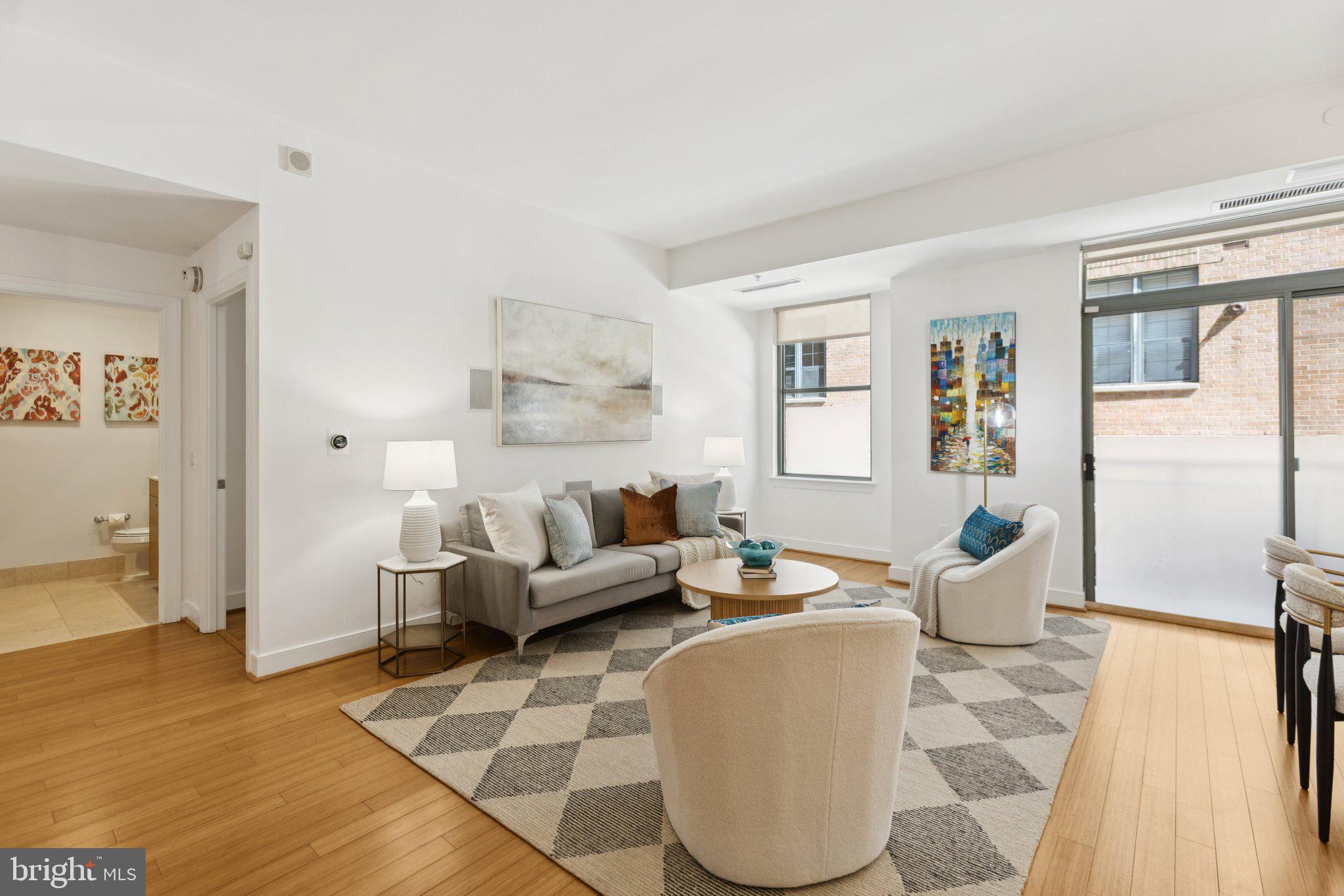 2425 L Street Northwest, Unit 210 Washington, DC 20037 - Photo 8 of 39 a living room with furniture and a table