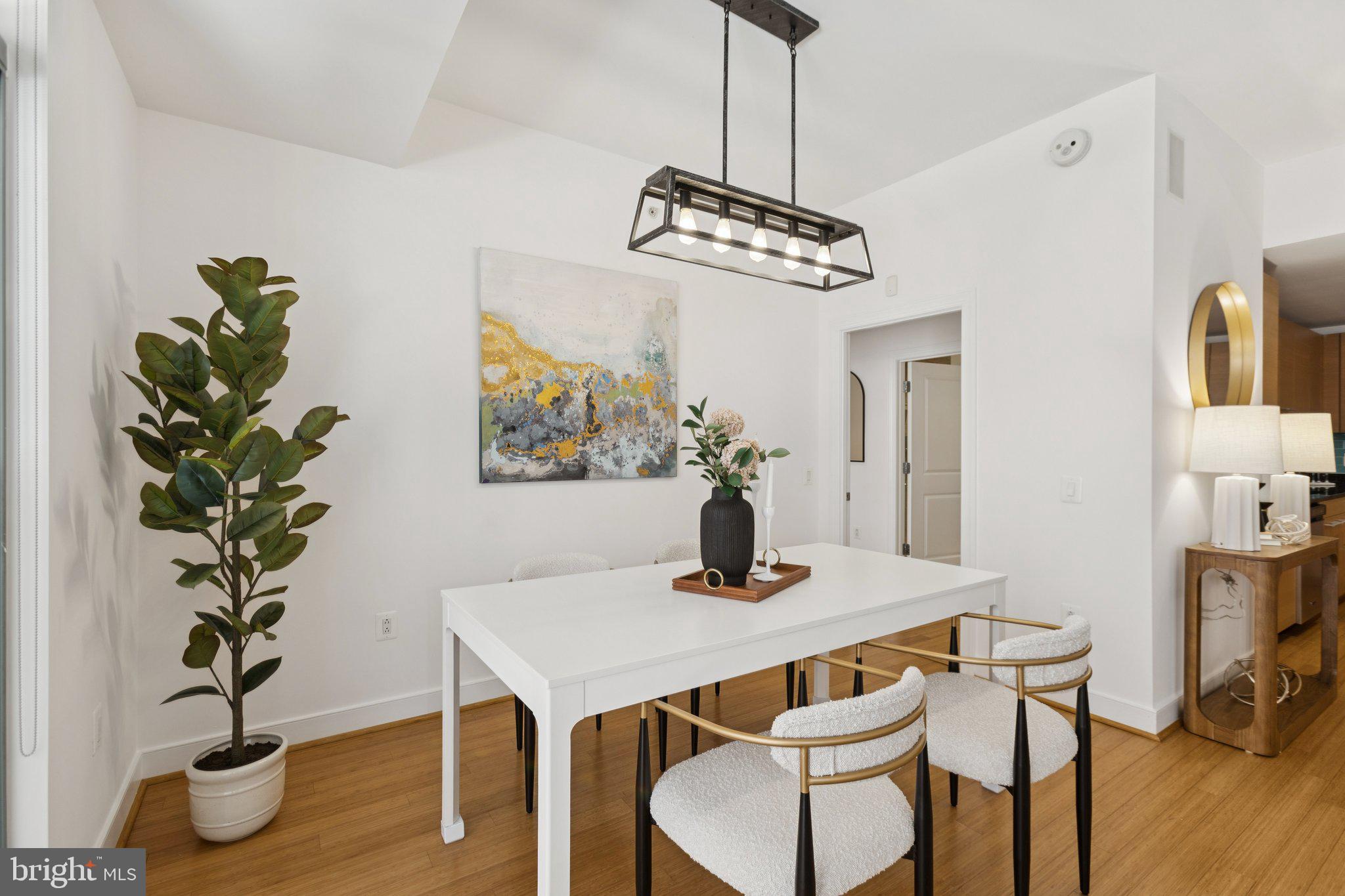 2425 L Street Northwest, Unit 210 Washington, DC 20037 - Photo 9 of 39 a view of a dining room with furniture wooden floor and chandelier