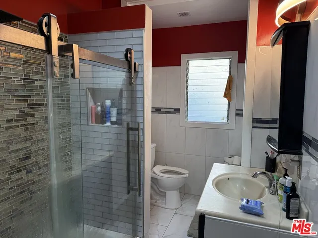 a view of a patio with table and chairs and potted plants