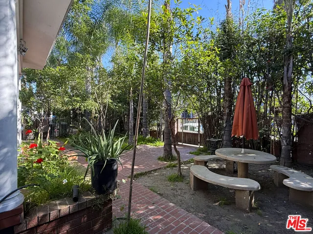 a view of a house with a tree in the background