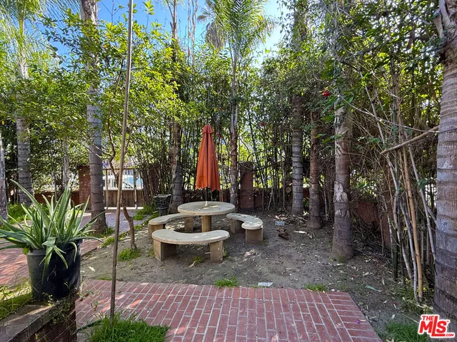 a view of a street with potted plants