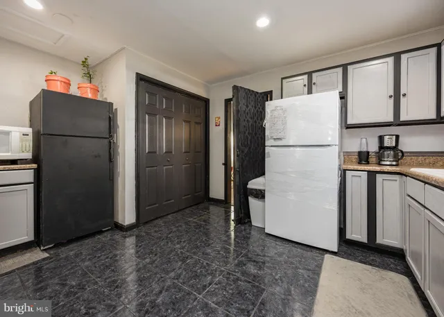a kitchen with stainless steel appliances granite countertop a refrigerator sink and stove