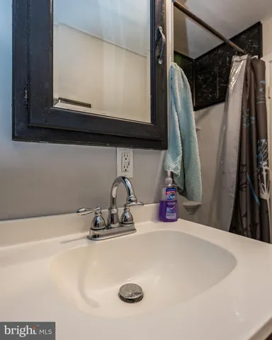 a bathroom with a sink a toilet and bathtub