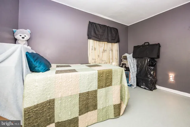 a bed sitting in a bedroom next to a window