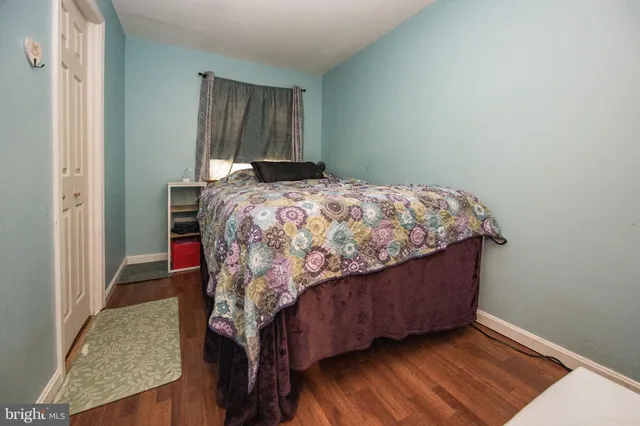 a living room with furniture a window and a wooden floor