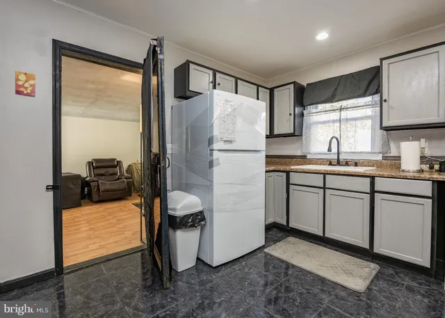 a kitchen with refrigerator and sink