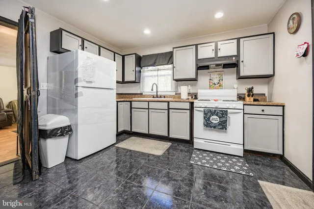 a kitchen with a sink cabinets and window