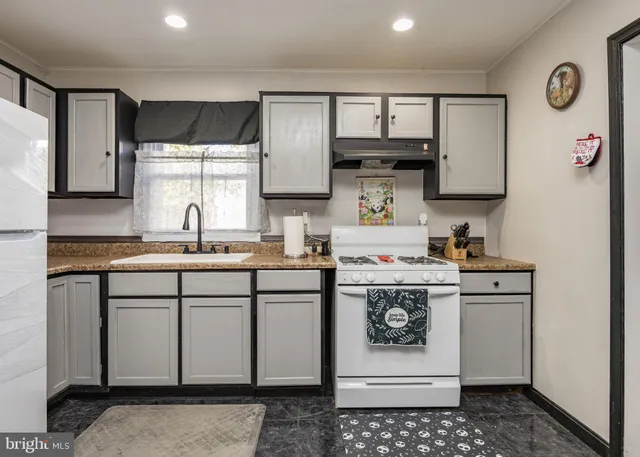 a white refrigerator freezer and a refrigerator in a kitchen