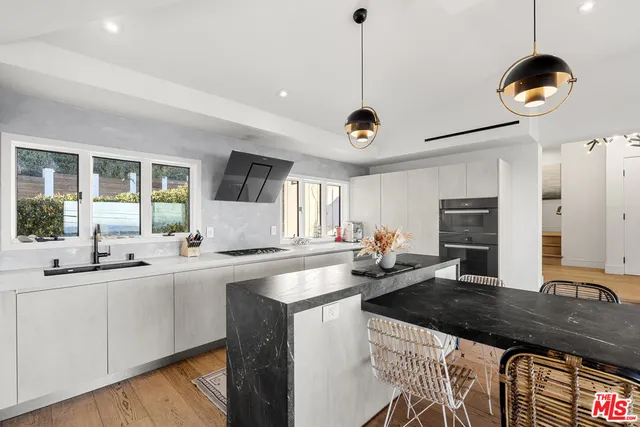 a kitchen with a sink stove and microwave