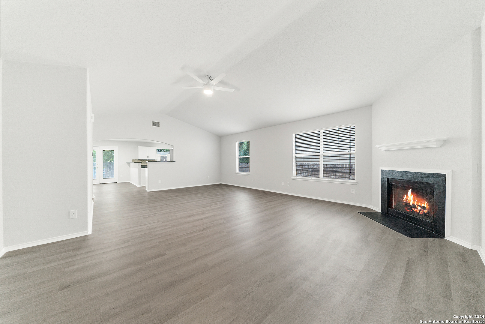 4116 Whisper Point Schertz, TX 78108 - Photo 1 of 28 an empty room with wooden floor fireplace and windows