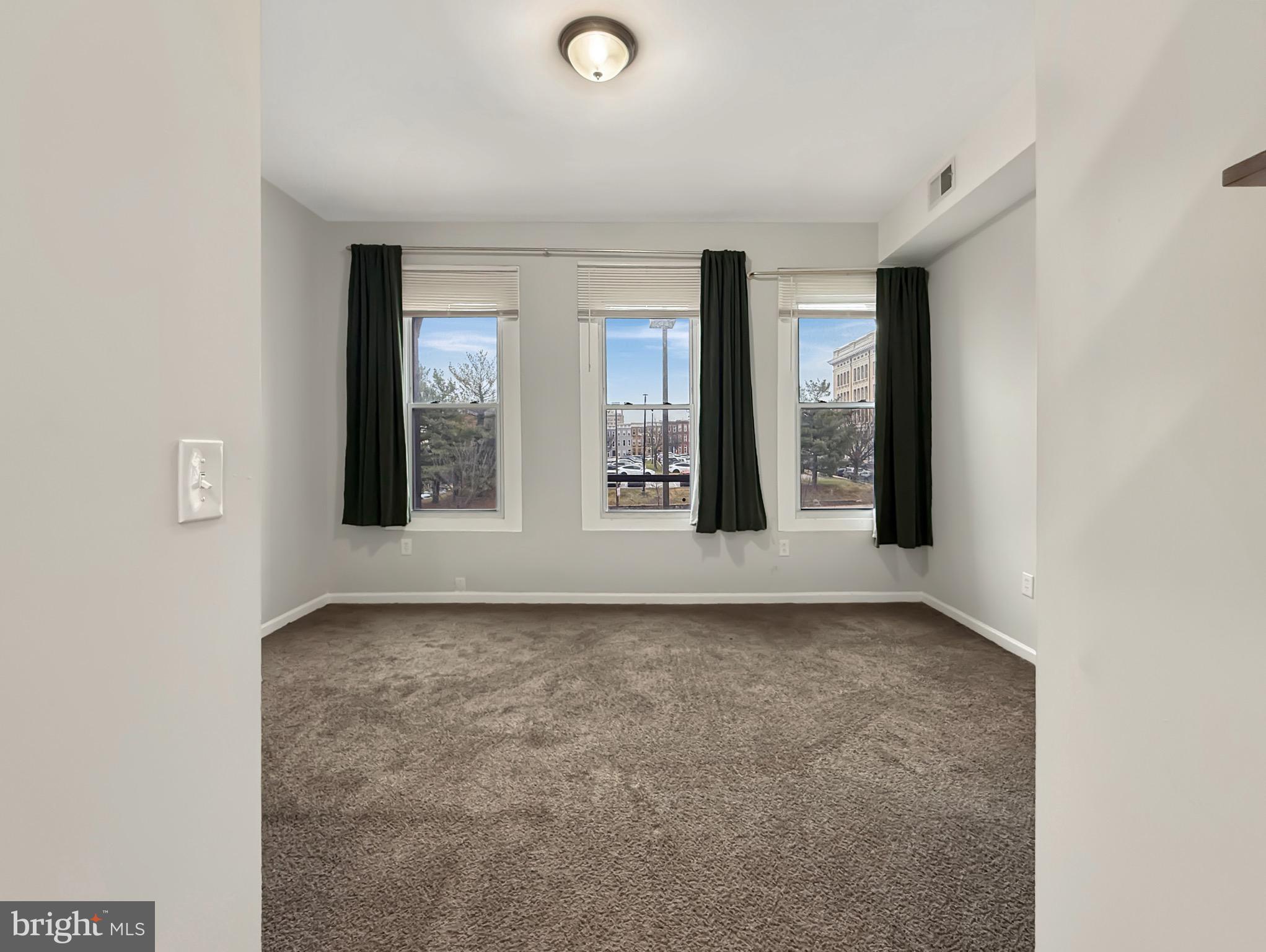 135 East North Avenue, Unit 2 Baltimore, MD 21202 - Photo 11 of 29 an empty room with windows and closet