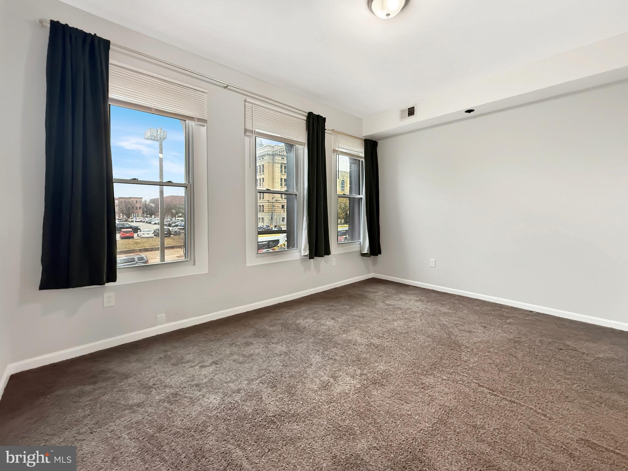 135 East North Avenue, Unit 2 Baltimore, MD 21202 - Photo 14 of 29 a view of an empty room with windows