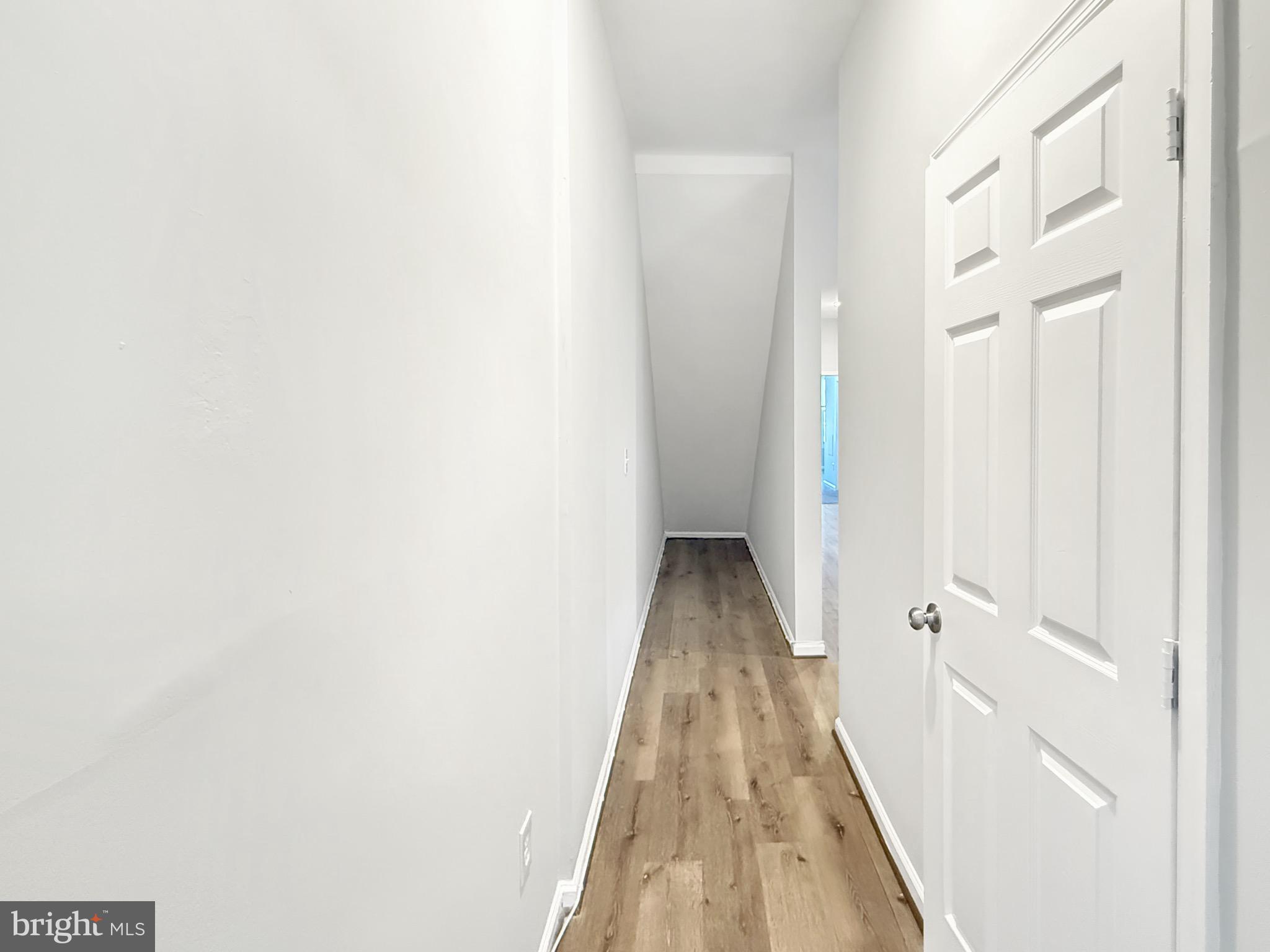 135 East North Avenue, Unit 2 Baltimore, MD 21202 - Photo 17 of 29 a view of a hallway with wooden floor and staircase