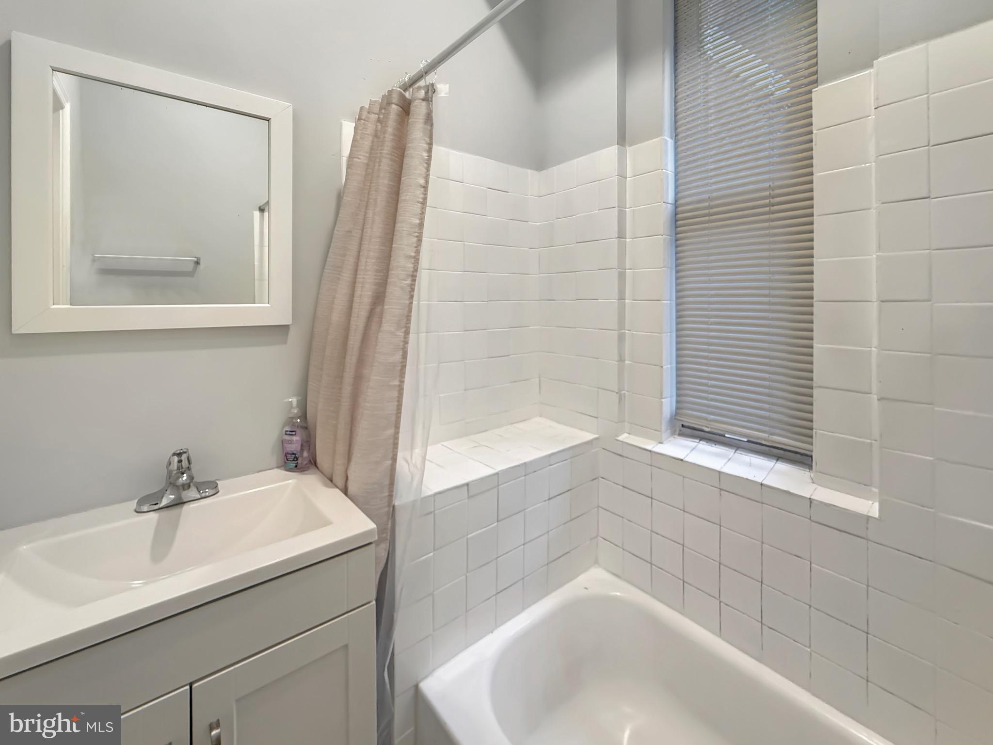 135 East North Avenue, Unit 2 Baltimore, MD 21202 - Photo 18 of 29 a bathroom with a sink and a bathtub