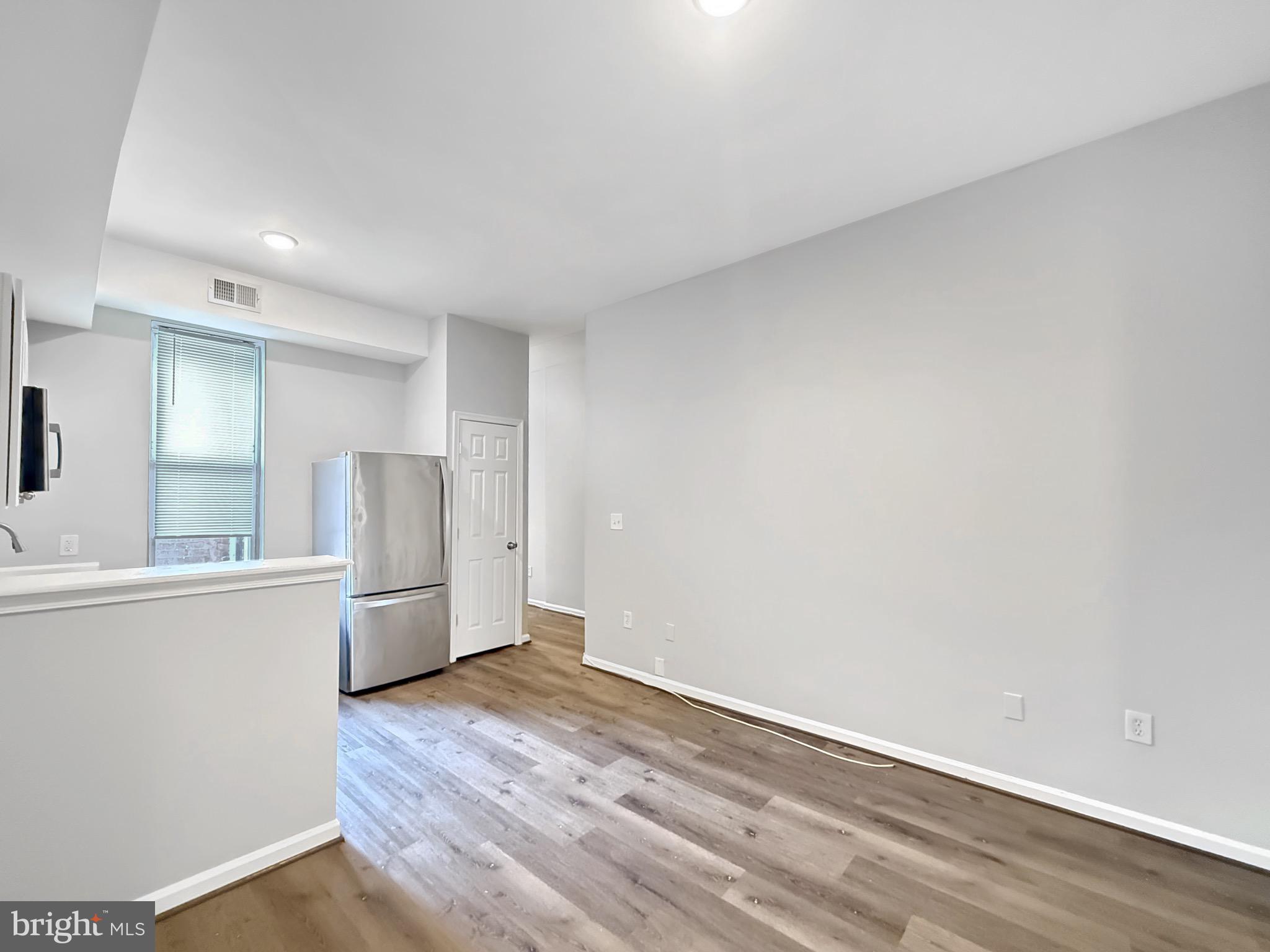 135 East North Avenue, Unit 2 Baltimore, MD 21202 - Photo 26 of 29 a view of a kitchen with wooden floor and a sink