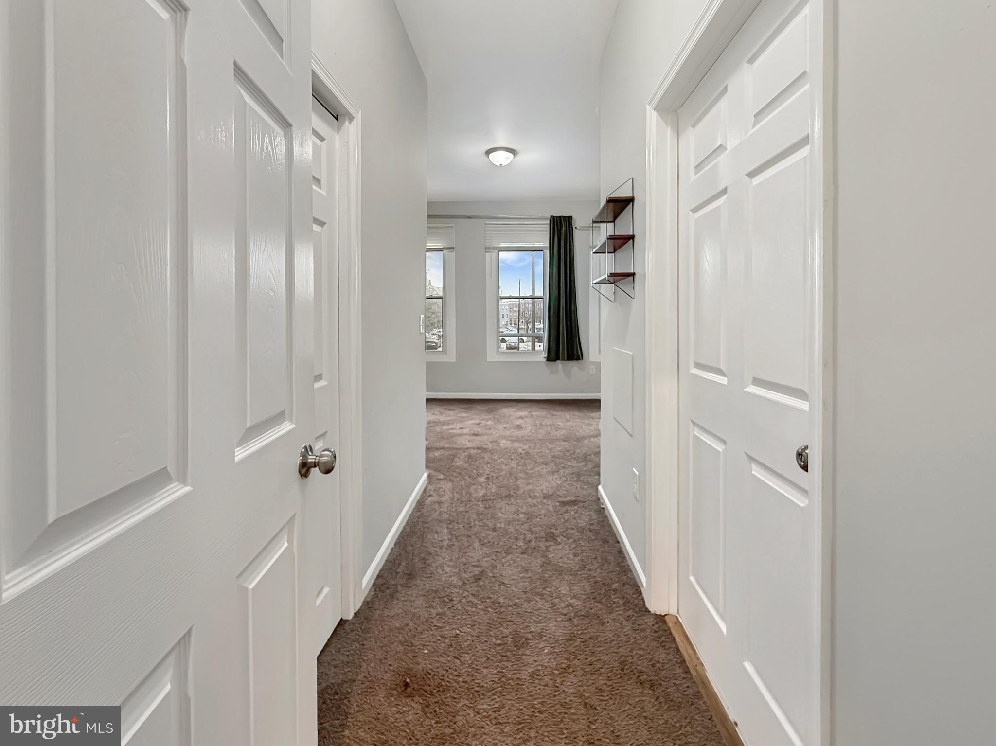 135 East North Avenue, Unit 2 Baltimore, MD 21202 - Photo 8 of 29 a view of a hallway with a wooden door