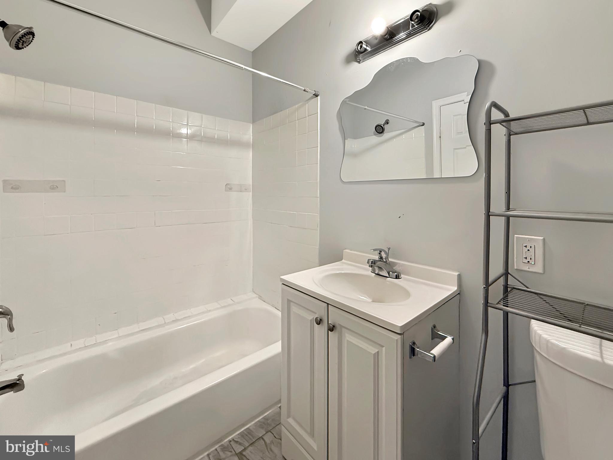 135 East North Avenue, Unit 2 Baltimore, MD 21202 - Photo 9 of 29 a bathroom with a sink and a mirror