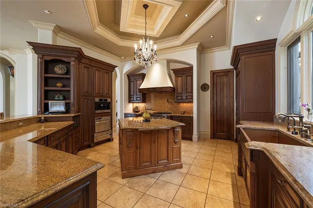 a living room with patio furniture and a potted plant