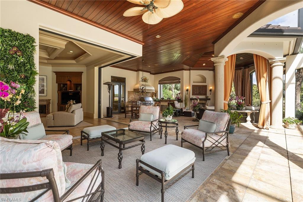 15167 Brolio Lane Naples, FL 34110 - Photo 15 of 50 a living room with patio furniture and a potted plant