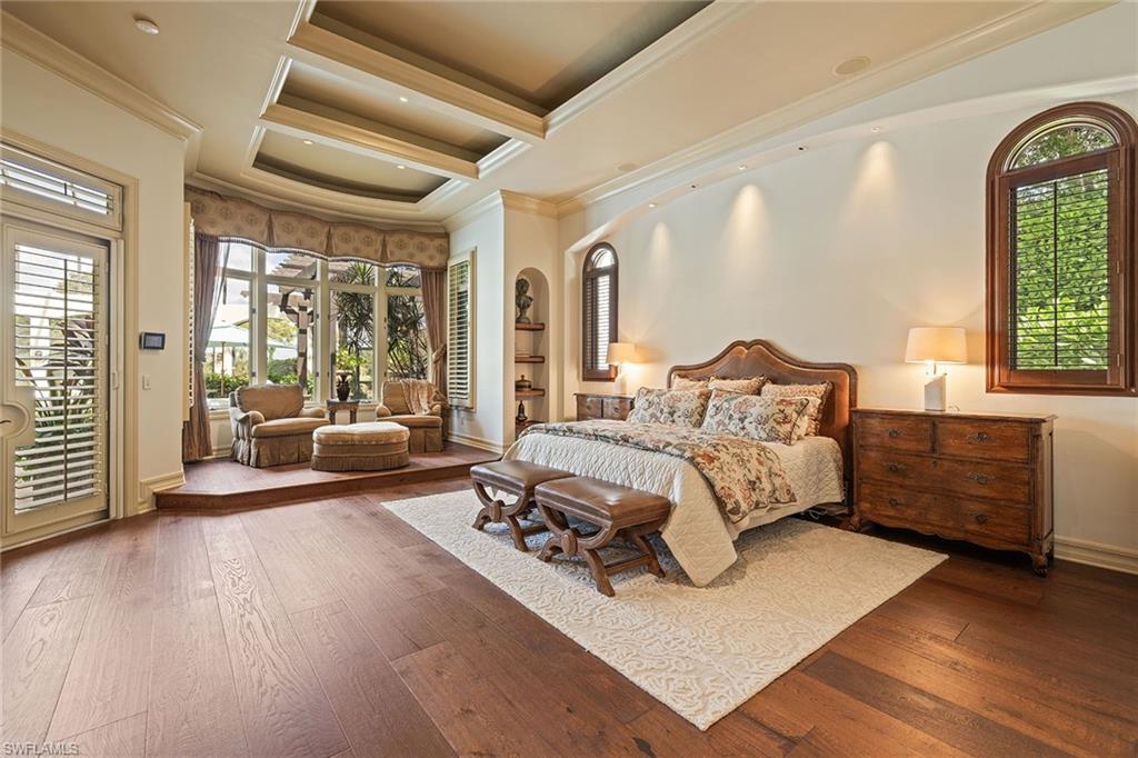 15167 Brolio Lane Naples, FL 34110 - Photo 18 of 50 a bedroom with furniture and a large window