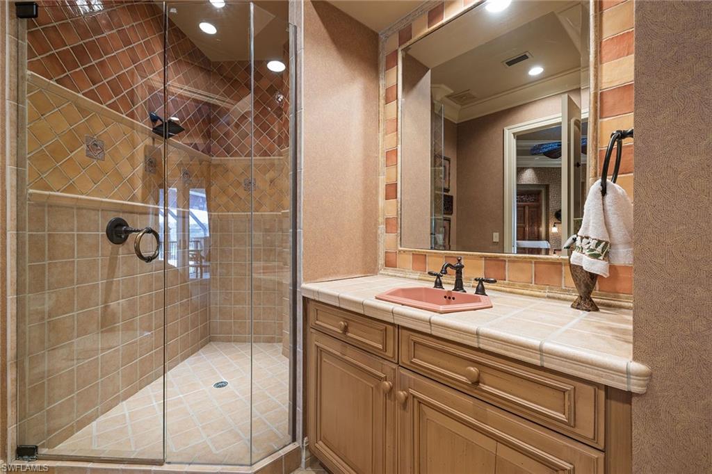 15167 Brolio Lane Naples, FL 34110 - Photo 26 of 50 a bathroom with a sink and a mirror