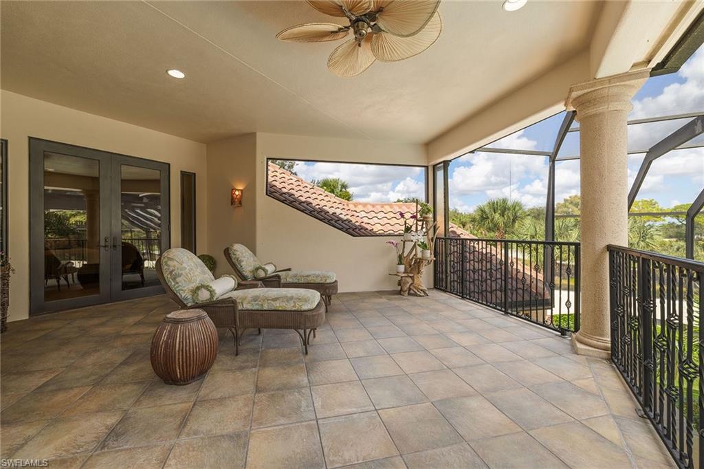 15167 Brolio Lane Naples, FL 34110 - Photo 29 of 50 a living room with furniture and a floor to ceiling window