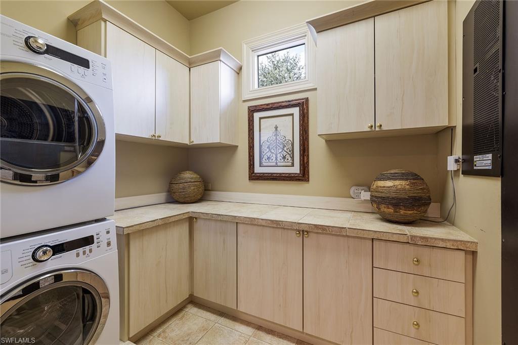 15167 Brolio Lane Naples, FL 34110 - Photo 30 of 50 a kitchen with a washer and dryer