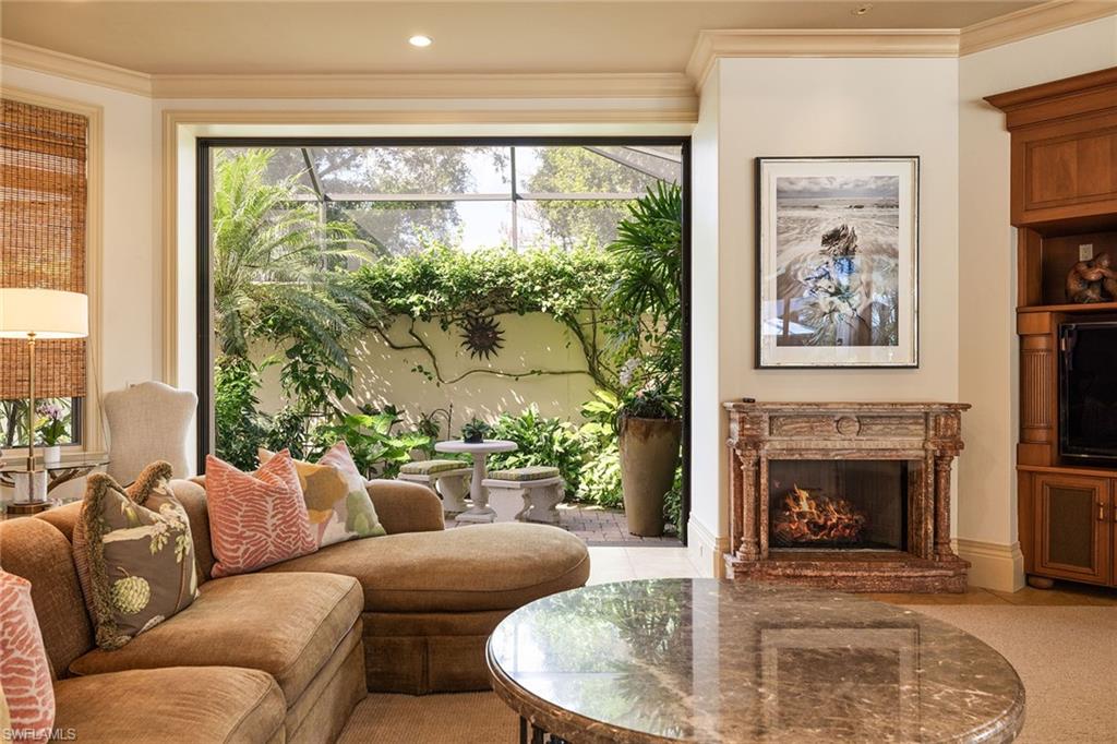 15167 Brolio Lane Naples, FL 34110 - Photo 3 of 50 a living room with furniture and a fireplace