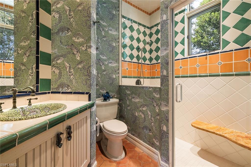 15167 Brolio Lane Naples, FL 34110 - Photo 33 of 50 a bathroom with a granite countertop sink and a toilet