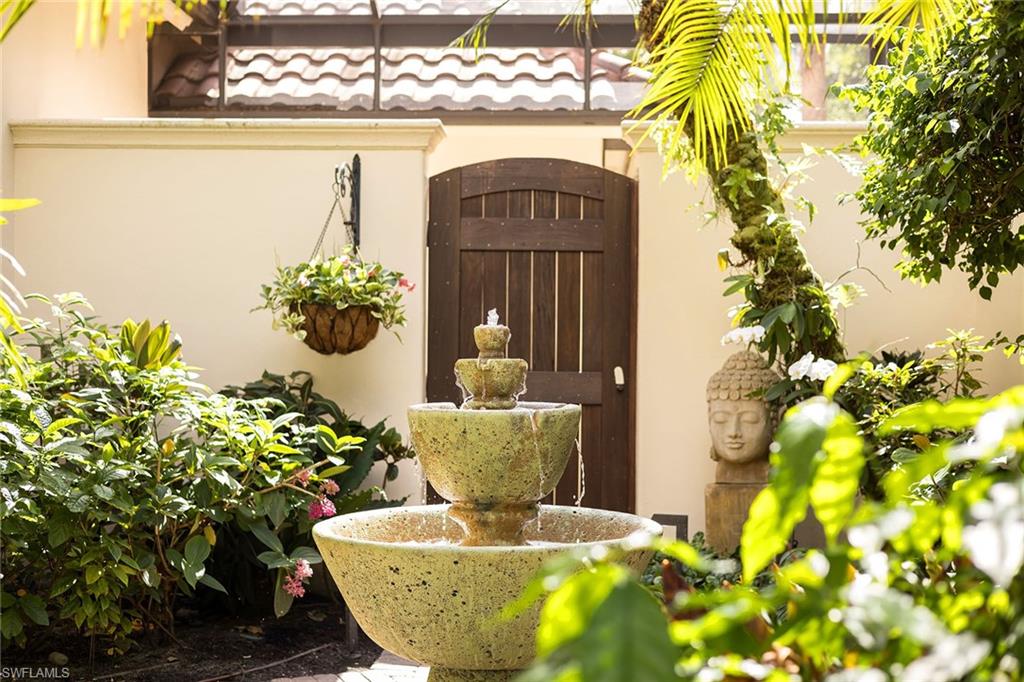 15167 Brolio Lane Naples, FL 34110 - Photo 36 of 50 a vase of flowers sitting on a table