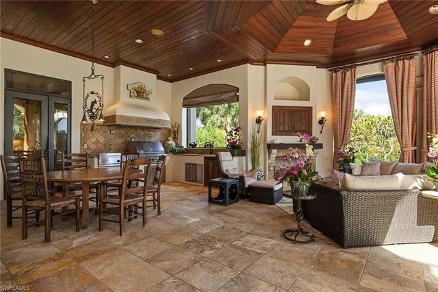 a view of a dining room with furniture and chandelier
