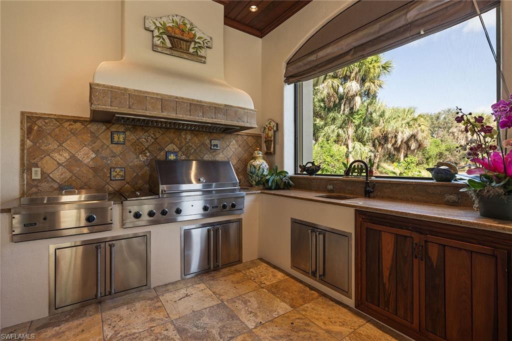 15167 Brolio Lane Naples, FL 34110 - Photo 42 of 50 a kitchen with stainless steel appliances a sink stove and cabinets