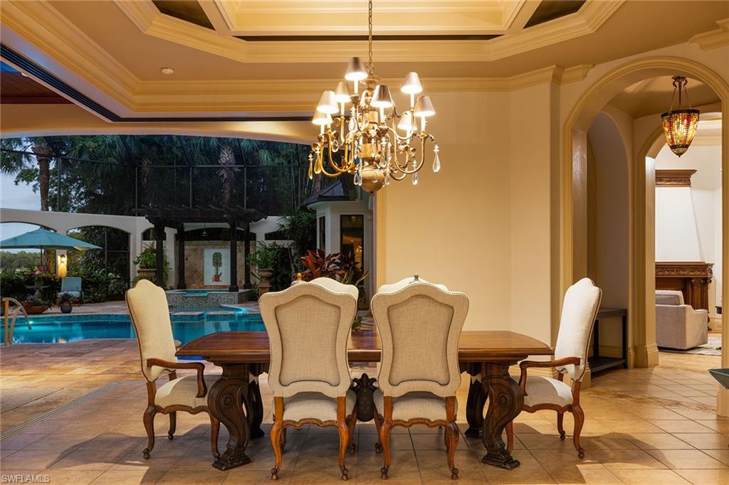 15167 Brolio Lane Naples, FL 34110 - Photo 44 of 50 a view of a dining room with furniture and chandelier